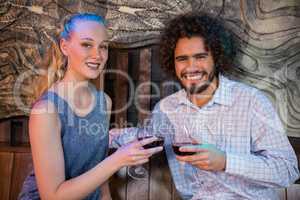 Couple toasting glass of wine in bar