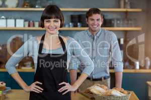 Portrait of waitress standing with hand on hip