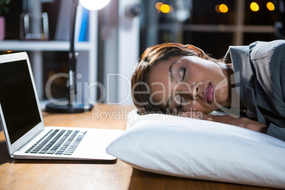 Businesswoman sleeping while working in office