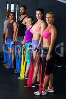 Male and female athletes exercising with resistance band