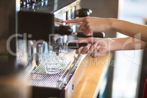 Waitress making cup of coffee