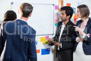 Group of businesspeople looking at whiteboard