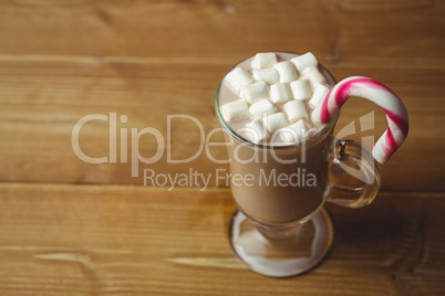 Cup of coffee with marshmallow and candy cane