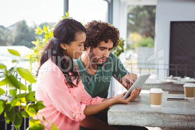 Couple using digital tablet