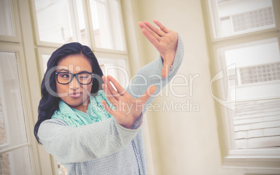 Composite image of asian woman making square with hands