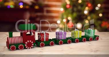 Composite image of train model carrying gift boxes