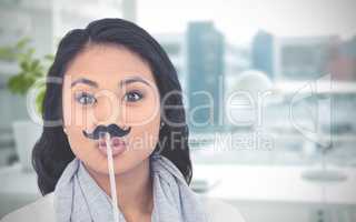 Composite image of pretty asian woman with fake mustache posing for camera
