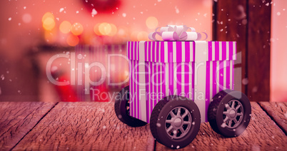 Composite image of gift on wheels