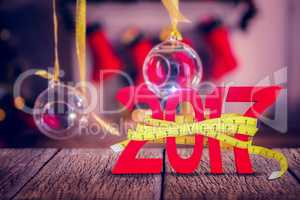 Composite image of digitally generated image of new year with tape measure
