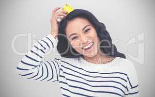 Composite image of smiling asian woman with paper crown