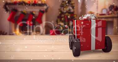 Composite image of red gift box on wheels