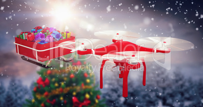 Composite image of high angle view of flying drone pulling chirstmas sledge