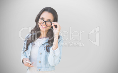 Composite image of brunette with smartphone