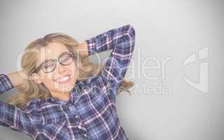 Composite image of a blonde hipster lying on the floor