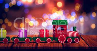 Composite image of train set with gift boxes