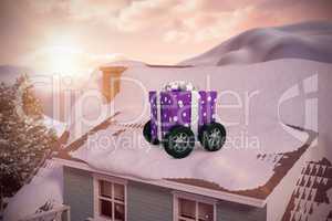 Composite image of purple wrapped with polka dot gift box on wheels