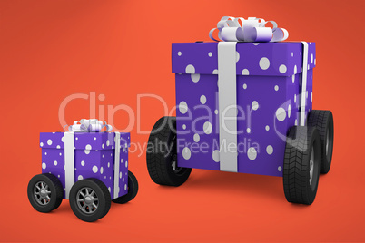 Composite image of gift box with gray ribbon on wheels