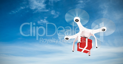 Composite image of digitally generated image of quadcopter with red gift box