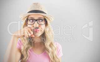 Composite image of a beautiful hipster having a fake mustache