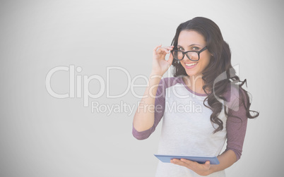 Composite image of brunette with tablet pc