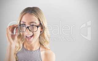 Composite image of gorgeous blonde hipster winking