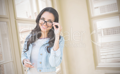 Composite image of brunette with smartphone