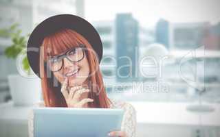 Composite image of smiling hipster woman using her tablet