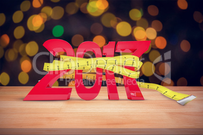 Composite image of new year with tape measure