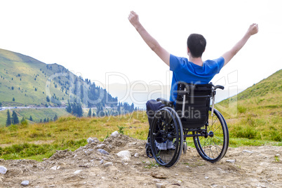 Optimistic handicapped man sitting on wheelchair