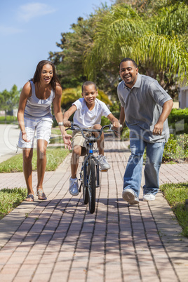 African American Family WIth Boy Riding Bike & Happy Parents