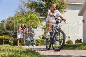 African American Family WIth Boy Riding Bike & Happy Parents