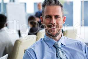 Smiling businessman sitting in office