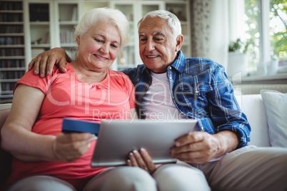 Senior couple doing online shopping on digital tablet