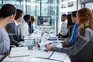 Business people looking at a screen during a video conference
