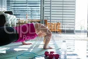 Woman doing exercise in living room