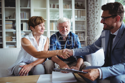 Financial advisor shaking hands with senior woman