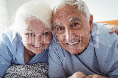 Senior couple relaxing on bed