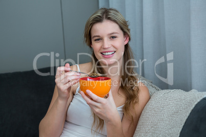 Woman having breakfast in living room