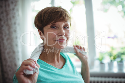 Senior woman holding towel around her neck