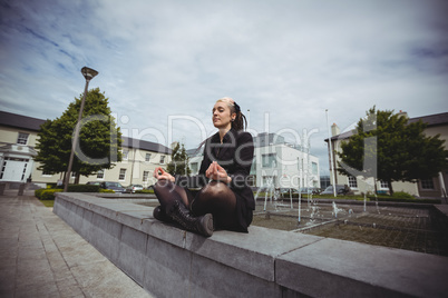 Businesswoman practicing yoga
