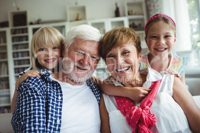 Portrait of grandparents smiling with their grandchildren