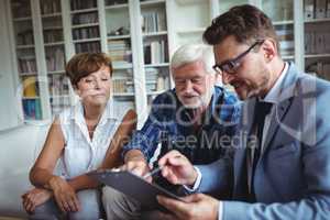 Senior couple planning their investments with financial advisor