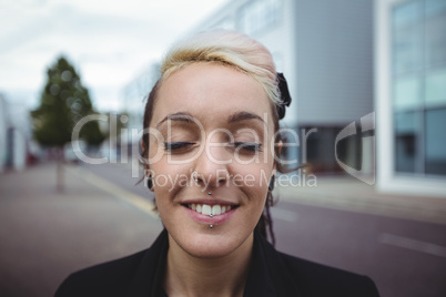 Businesswoman standing with eyes closed
