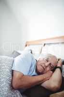 Senior man sleeping on bed