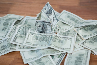 Lots of dollar bank notes scattered on the table