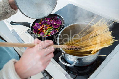 Woman cooking food in kitchen