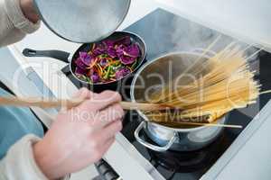 Woman cooking food in kitchen