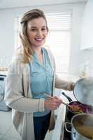 Woman cooking food in kitchen