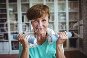 Senior woman exercising with dumbbells