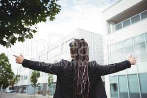 Businesswoman standing with arms outstretched